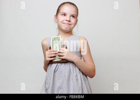 Beautiful little girl with cash money dollars US Stock Photo