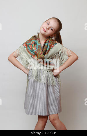 Russian little girl in traditional Pavloposadskij scarf dancing Stock Photo
