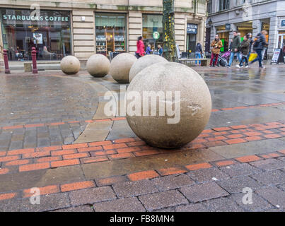 A number of concrete ball in a semi-circle causing a no pass for vehicle traffic in a pedestrian area. Stock Photo