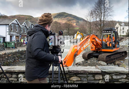 TV Cameraman Filming the Aftermath of the Glenridding Floods Caused by Storm Desmond in December 2015 Lake District Cumbria Stock Photo