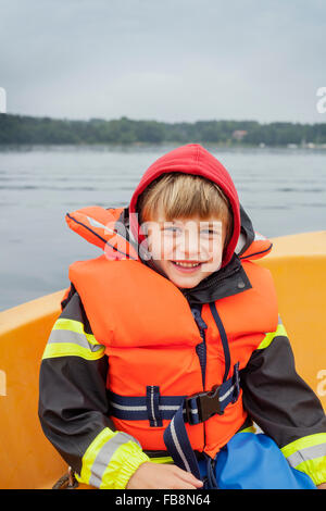 Sweden, Uppland, Runmaro, Barrskar, Portrait of boy (6-7) on boat