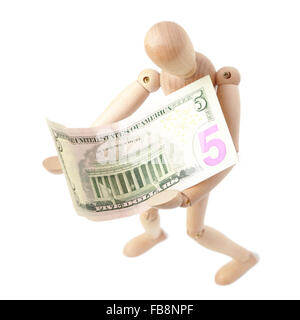 Wooden man toy and dollars Stock Photo