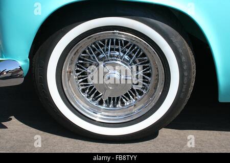 Close-up detail of a front tire and spoked hubcap on a 1955 Ford Thunderbird Stock Photo