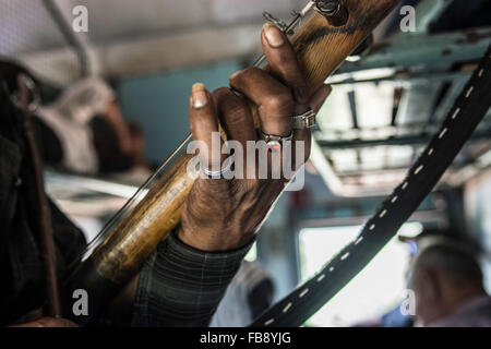 Traveling musician playing for passengers on an Indian train. Stock Photo