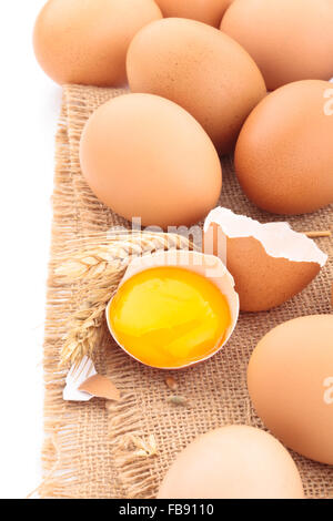 Closeup shot of fresh chicken eggs on sackcloth. Stock Photo