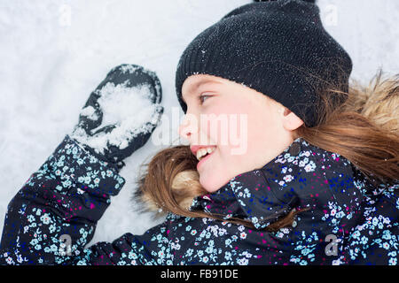 Girl in winter clothes. Happy child outside photo Stock Photo
