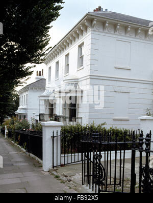 Exterior of a large, white painted, Victorian town house with canopies above the windows Stock Photo