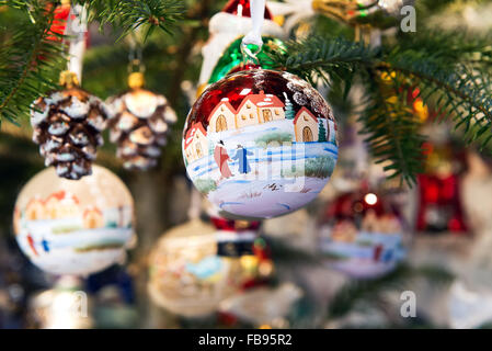 Colorful decorative Christmas balls or baubles depicting holiday or winter scenes Stock Photo