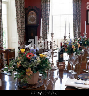 Floral arrangements on table set for lunch with silver candelabra Stock Photo