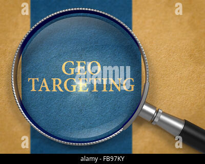 Geo Targeting through Magnifying Glass on Old Paper with Dark Blue Vertical Line Background. Stock Photo