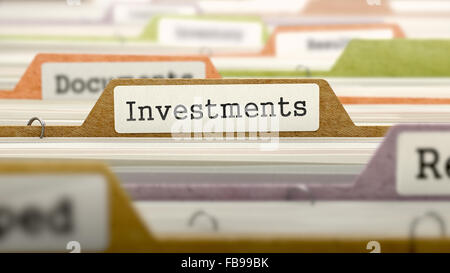 File Folder Labeled as Investments in Multicolor Archive. Closeup View. Blurred Image. Stock Photo