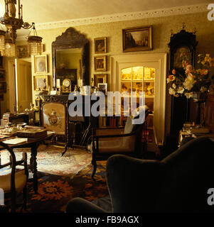 Large antique mirror above fireplace in drawing room in Jacobean rectory Stock Photo