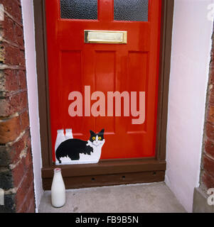 Close-up of a cat painted on a red sixties front door