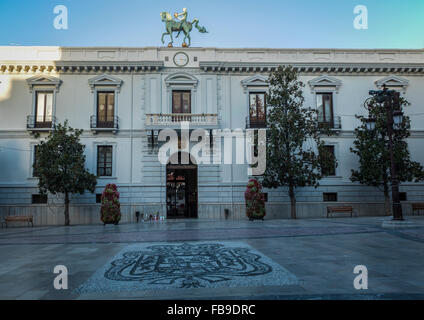 Evening view of the Town Hall in Granada in Spain with the symbol of Granada, the pomegranate on the floor of the main square. Stock Photo