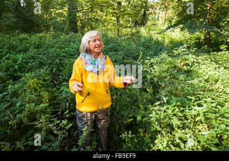 German edible wild herb expert Heidemarie Fritsche leads a herb walk through Schlossgarten Berlin-Buch, Berlin, Germany on Octob Stock Photo