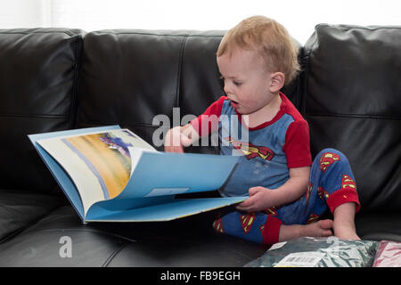 Denver, Colorado - Fifteen-month-old Adam Hjermstad, Jr. looks at a book he got for Christmas. Stock Photo