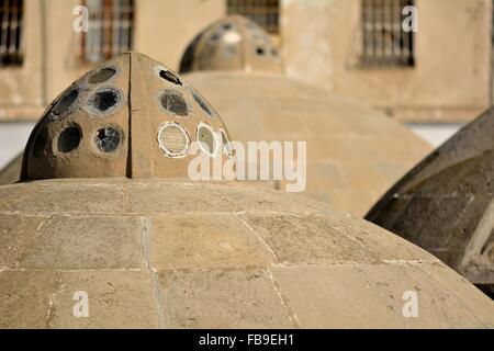 Round ancient roofs of public baths in Baku Old City, within the capital of Azerbaijan Stock Photo