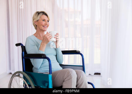 cheerful disabled woman holding hot coffee cup at home Stock Photo - Alamy