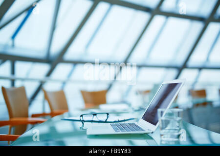 Laptop standing on the table in modern office Stock Photo