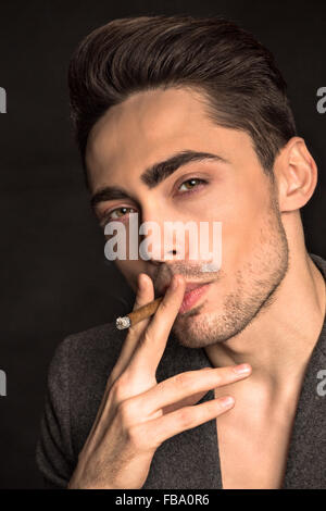 Model man smoking in studio Stock Photo