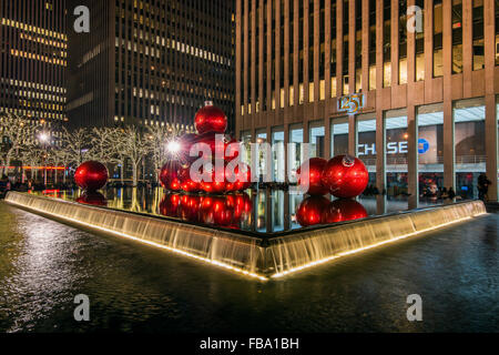 Giant red Christmas ornaments on display on Avenue of Americas (6th Avenue) during the holiday season, Manhattan, New York, USA Stock Photo