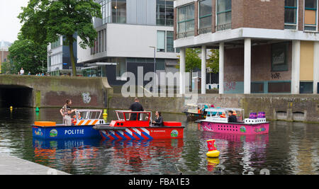 ROTTERDAM, NETHERLANDS - JUNE 28, 2015: Unknnown kids having fun in miniature boats on a canal in the Rotterdam city center.