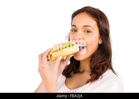 Smiling woman eating sandwich Stock Photo