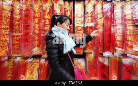 Shenyang, China's Liaoning Province. 13th Jan, 2016. A lady buys Chinese couplets for Lunar New Year celebration at a supermarket in Shenyang, capital city of northeast China's Liaoning Province, Jan. 13, 2016. © Long Lei/Xinhua/Alamy Live News Stock Photo