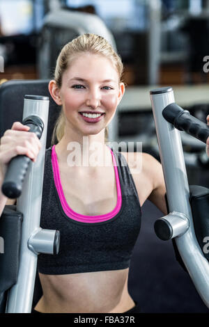 Using Excercise Machine Girl using an exercise machine Stock Photo - Alamy