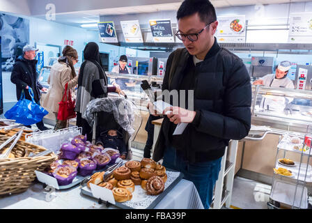 Paris, France, Chinese Man Shopping, Buying, in Danish DIY Housewares Store,  IKEA customers Selecting Food in Self Serve Cafeteria Stock Photo