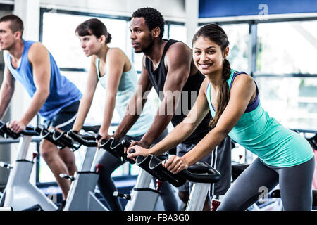 Fit people working out at spinning class Stock Photo - Alamy