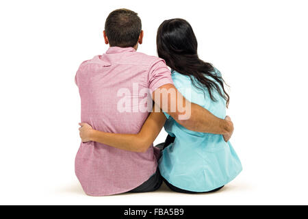 Rear view of couple hugging sitting Stock Photo