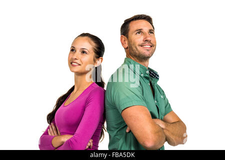 Thoughtful couple standing back to back looking away Stock Photo