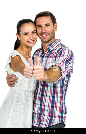 Young couple showing thumbs up at camera Stock Photo