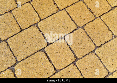 closeup of a yellow stone wall or a stone pavement background in diagonal Stock Photo