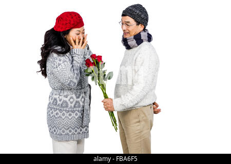 Older asian man giving his wife flowers Stock Photo