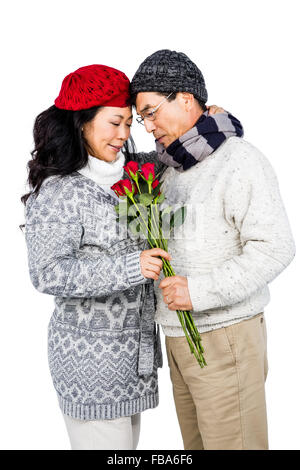 Older asian man giving his wife flowers Stock Photo