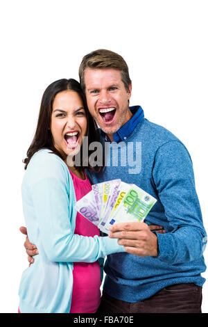 Excited couple holding money Stock Photo