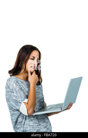 Confused woman using laptop Stock Photo