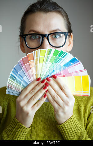 Woman in a glasses looking to a color paint palette Stock Photo