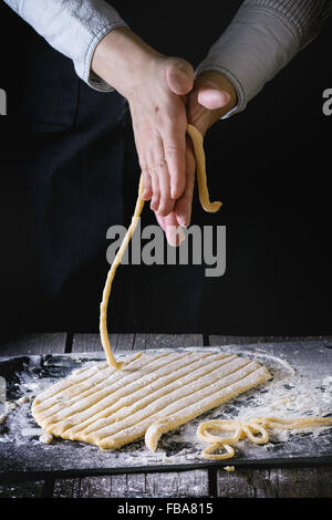 Making pasta by female hands Stock Photo