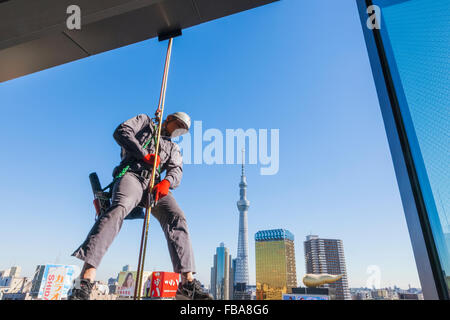 Japan, Honshu, Tokyo, Asakusa, Tokyo Sky Tree and Window Cleaner Stock Photo
