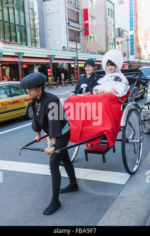 Japan, Honshu, Tokyo, Asakusa, Couple in Rickshaw Stock Photo