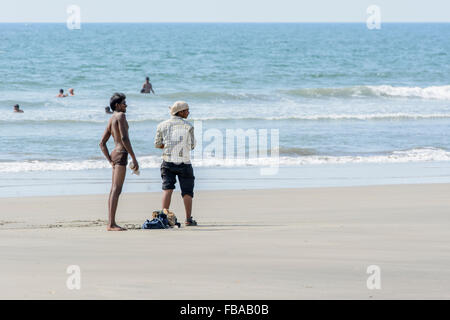 Two young local boys enjoy the beach life on Mandrem beach, North Goa, India Stock Photo