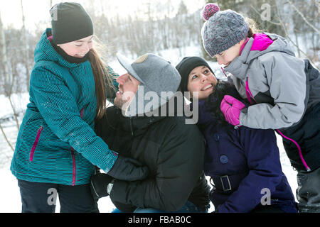 Happy parents and their kids in winterwear Stock Photo