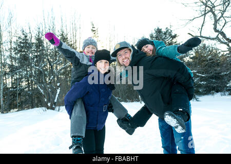 Happy parents and their kids in winterwear Stock Photo