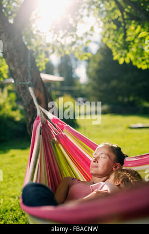 Finland, Heinola, Paijat-Hame, Woman embracing girl (4-5) in hammock