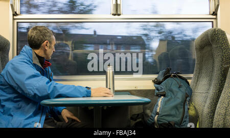 Mature male hiker on 7.am early morning train from Middlesbrough to Whitby on the picturesque Esk Valley Railway. Stock Photo