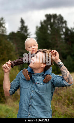 Finland, Uusimaa, Raasepori, Karjaa, Father holding son (12-17 months) piggyback