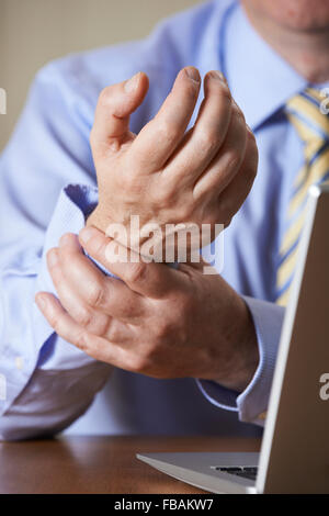 Businessman Suffering From Repetitive Strain Injury (RSI) Stock Photo